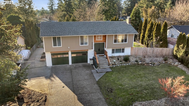 raised ranch with a front yard and a garage