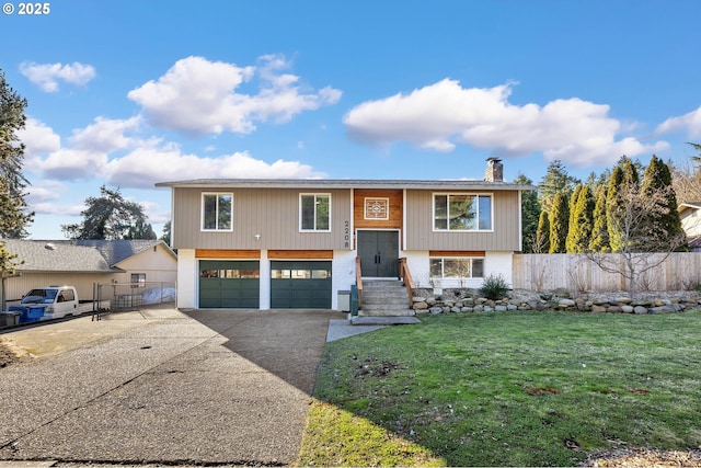 split foyer home with a front yard and a garage