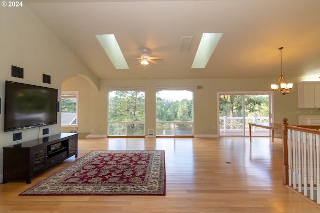 88378 Collard Lake Rd, Florence, OR 97439 - living area featuring a skylight, light wood finished floors, a chandelier, a ceiling fan, and high vaulted ceiling