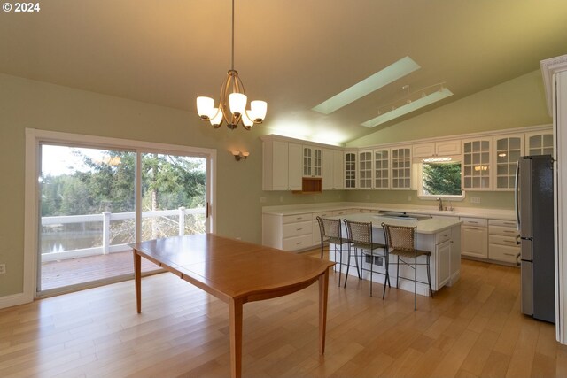 88378 Collard Lake Rd, Florence, OR 97439 - kitchen with a sink, freestanding refrigerator, light countertops, light wood-style flooring, and a kitchen island