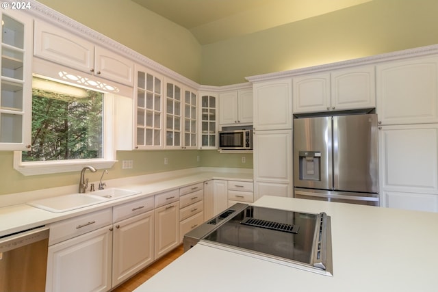 88378 Collard Lake Rd, Florence, OR 97439 - kitchen with appliances with stainless steel finishes, a sink, glass insert cabinets, white cabinets, and light countertops