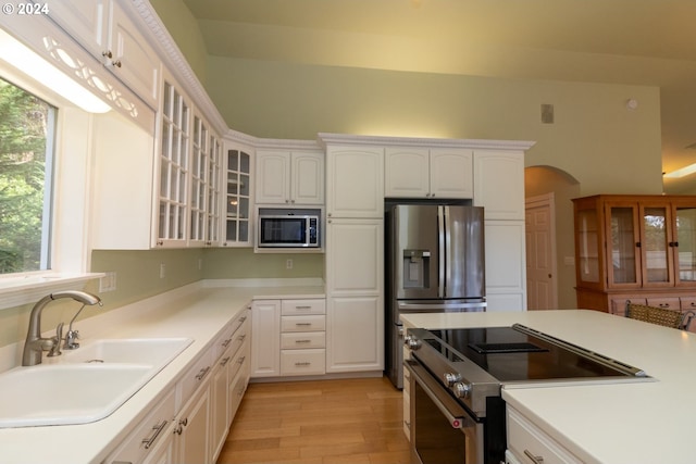 88378 Collard Lake Rd, Florence, OR 97439 - kitchen featuring stainless steel appliances, a sink, white cabinetry, and glass insert cabinets