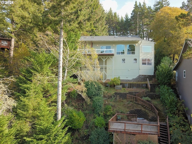 rear view of property featuring a wooden deck