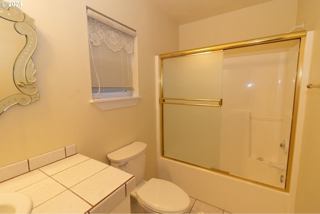 full bathroom featuring tile patterned flooring, vanity, bath / shower combo with glass door, and toilet