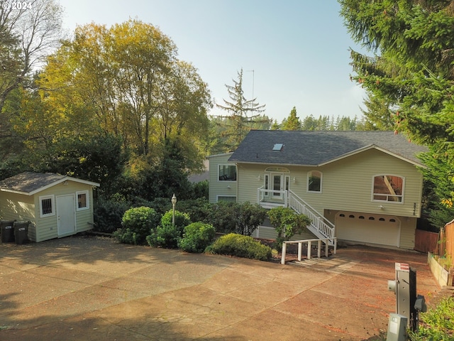 view of front of home featuring a storage unit and a garage