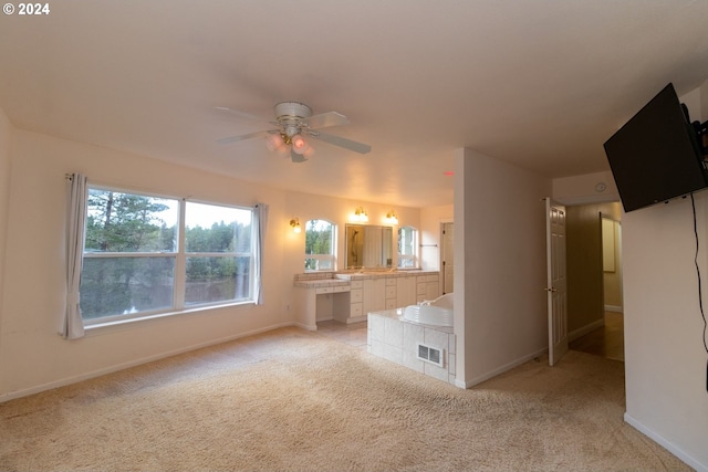 interior space featuring ceiling fan and light colored carpet