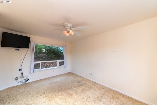 carpeted empty room featuring ceiling fan