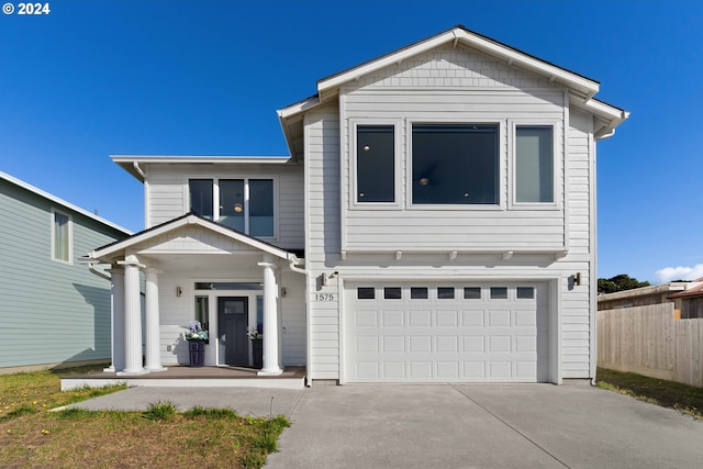 view of front of home featuring covered porch and a garage