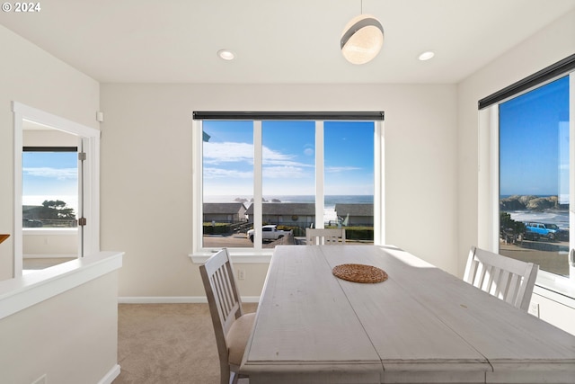 carpeted dining space with recessed lighting and baseboards