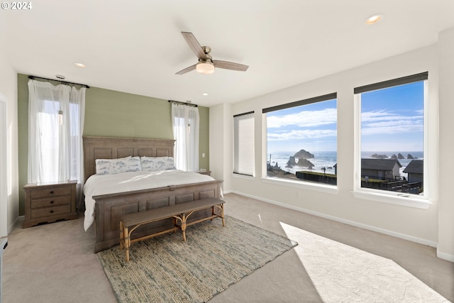 carpeted bedroom featuring baseboards, ceiling fan, and recessed lighting