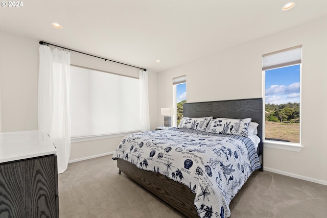 bedroom with recessed lighting, baseboards, and light carpet