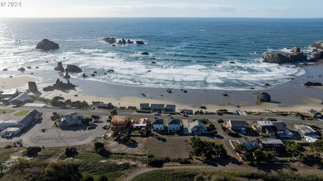 birds eye view of property featuring a beach view and a water view