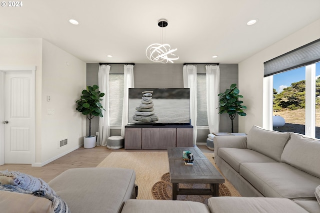 living area featuring recessed lighting, baseboards, visible vents, and light wood-style floors
