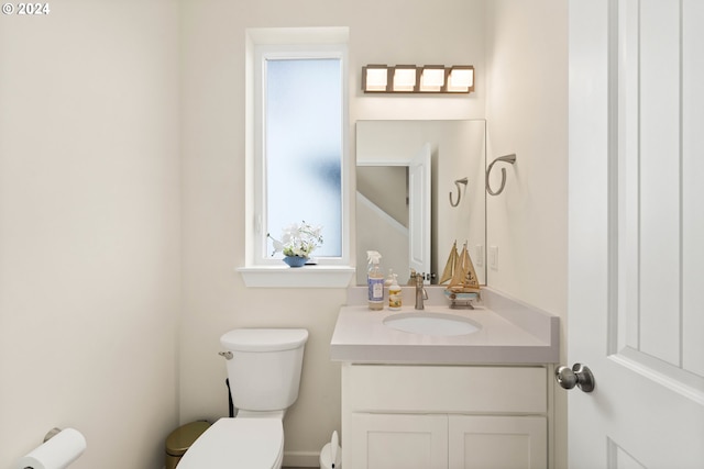 half bath featuring toilet and vanity