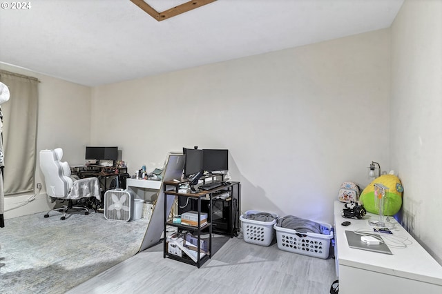 home office with light hardwood / wood-style flooring