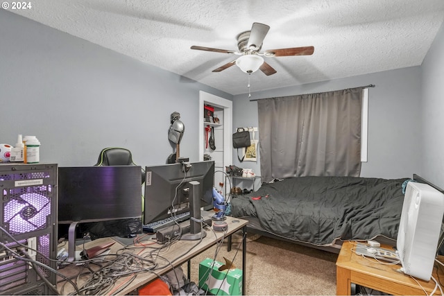 carpeted bedroom with ceiling fan and a textured ceiling