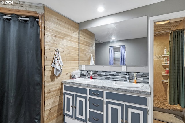 bathroom with vanity, backsplash, and wood walls