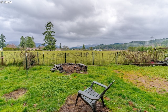 view of yard featuring a mountain view and a rural view