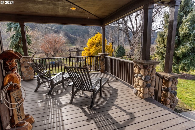 wooden terrace featuring a mountain view and a gazebo