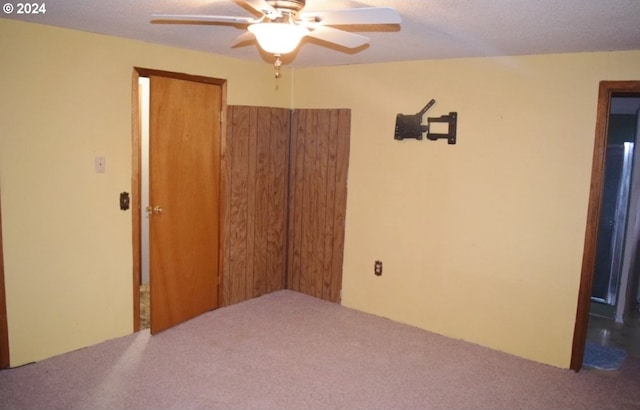 unfurnished bedroom with carpet flooring, ceiling fan, and a closet