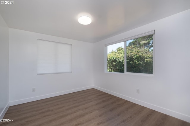 unfurnished room featuring dark hardwood / wood-style floors