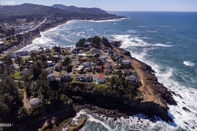 drone / aerial view featuring a water and mountain view