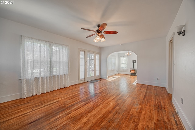 spare room featuring ceiling fan with notable chandelier and light hardwood / wood-style flooring