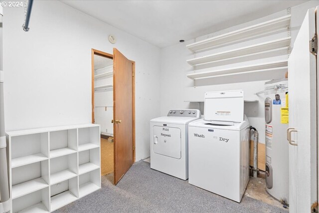 washroom with washing machine and dryer and electric water heater