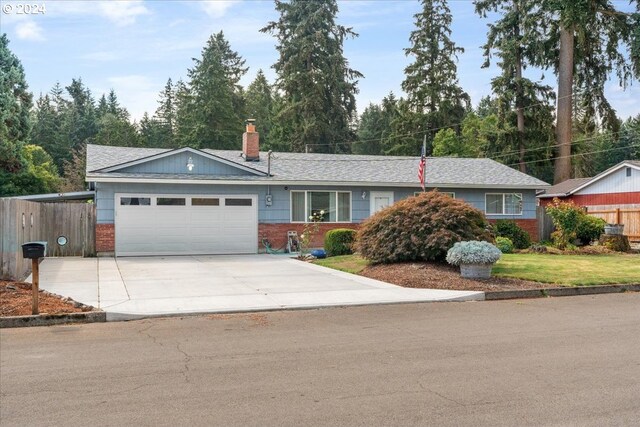 single story home with a garage and a front yard