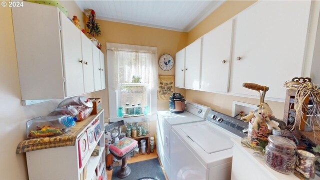 laundry room with independent washer and dryer, crown molding, and cabinets