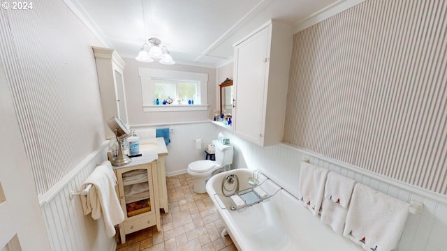 bathroom featuring crown molding, toilet, and a notable chandelier