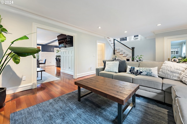 living room featuring dark wood-type flooring and ornamental molding