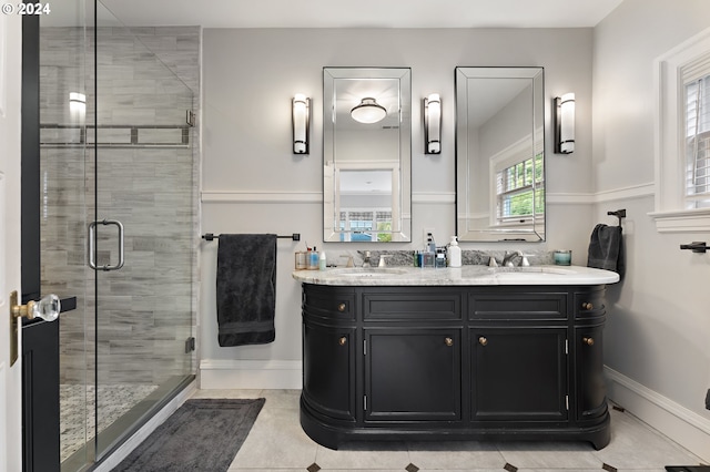 bathroom featuring vanity, an enclosed shower, and tile patterned flooring