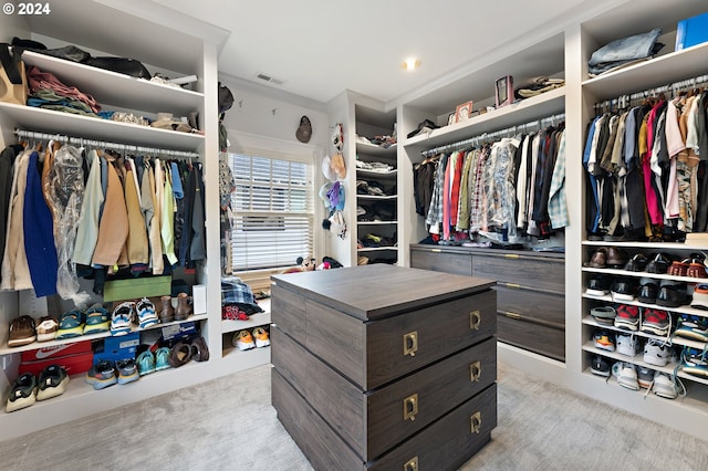 walk in closet featuring light carpet