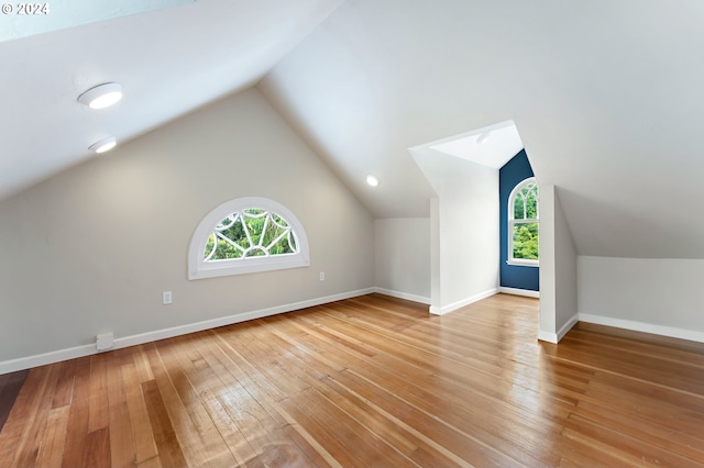 bonus room with lofted ceiling and wood-type flooring