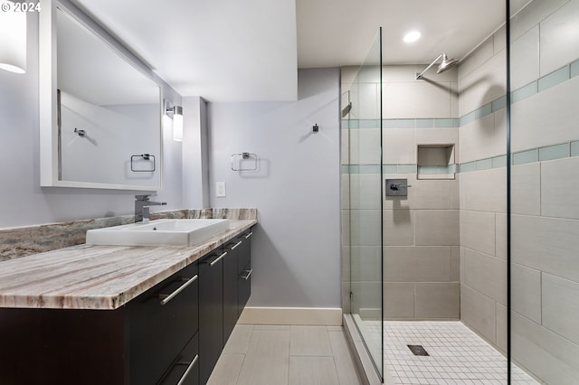 bathroom featuring vanity, an enclosed shower, and tile patterned floors