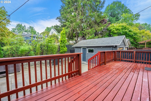 wooden terrace featuring an outdoor structure