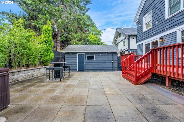 view of patio / terrace with an outbuilding and a deck