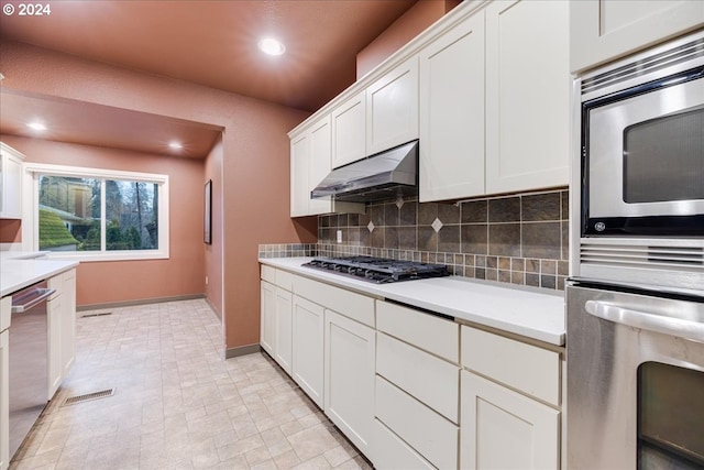 kitchen featuring white cabinetry, backsplash, and stainless steel appliances