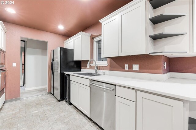 kitchen featuring appliances with stainless steel finishes, sink, and white cabinetry