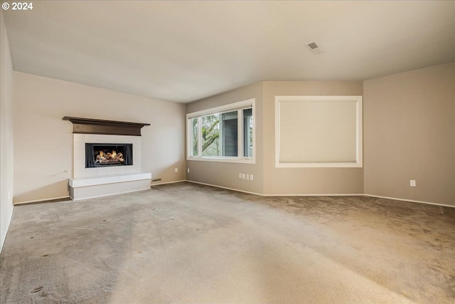 unfurnished living room featuring a fireplace and carpet floors