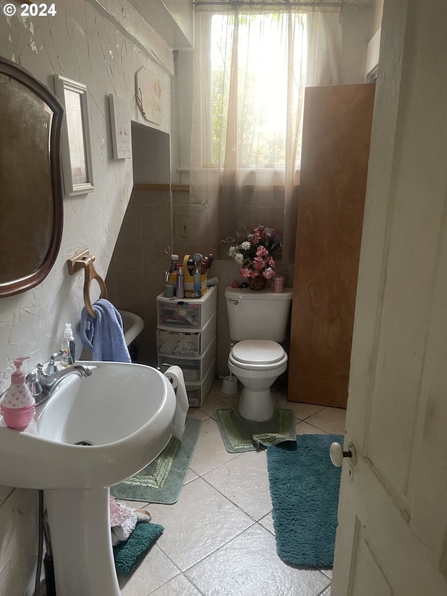 bathroom with toilet and tile patterned floors