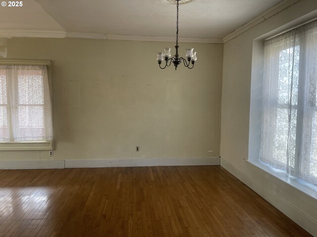 details featuring a wood stove, ornamental molding, and hardwood / wood-style flooring