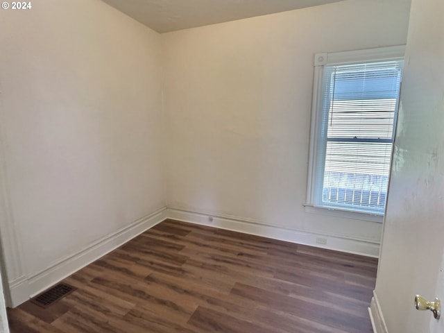 spare room featuring dark hardwood / wood-style flooring