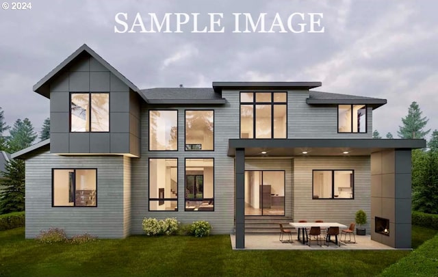 rear view of property featuring entry steps, a patio area, and a yard