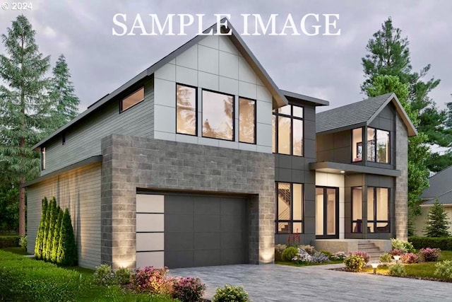 view of front of property with decorative driveway and an attached garage