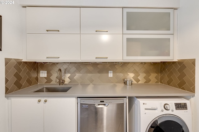 kitchen featuring white cabinets, dishwasher, and washer / dryer