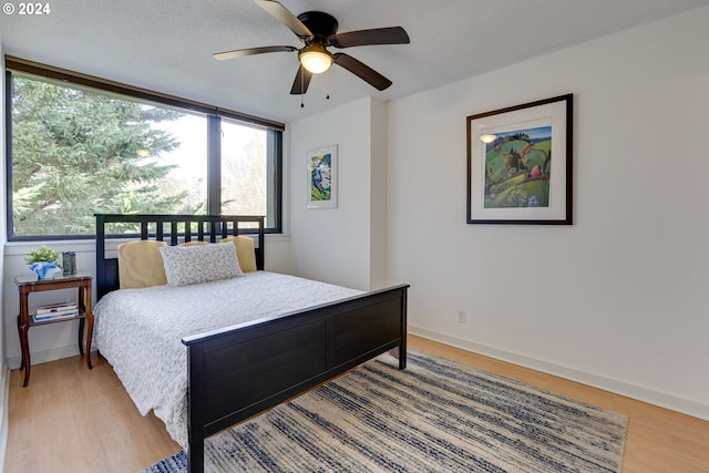 bedroom featuring ceiling fan and light wood-type flooring