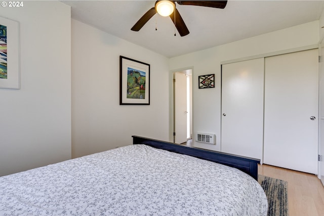 bedroom with ceiling fan, a closet, and light hardwood / wood-style floors