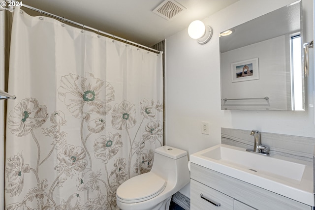 bathroom featuring vanity and toilet